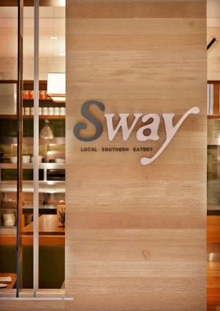 Sway retail storefront buildout with wood-slat entry