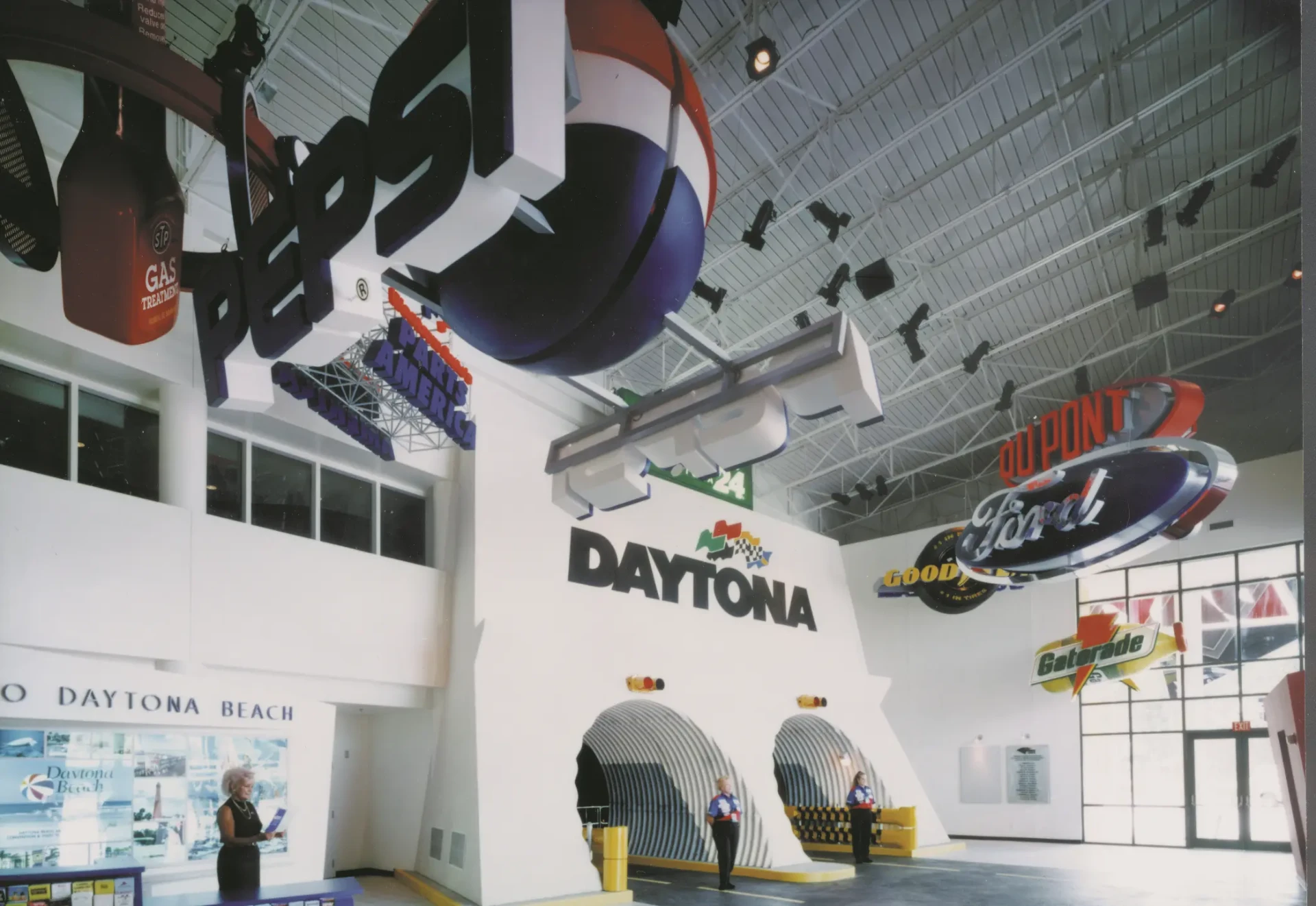 Daytona USA lobby with tunnel entrances and suspended sponsor signage